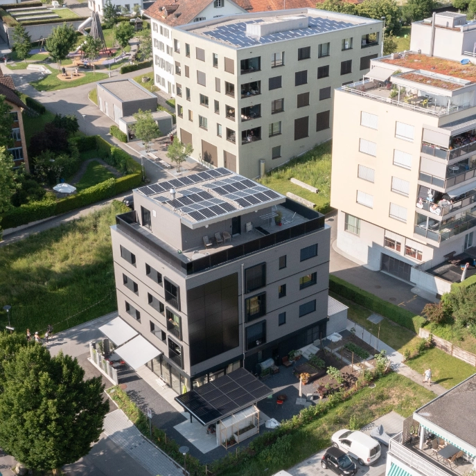 Das Gebäude Goldermattenstrasse 25 in Steinhausen mit Solarfassade, Solardach, Solarbalkon und Solarpergola.